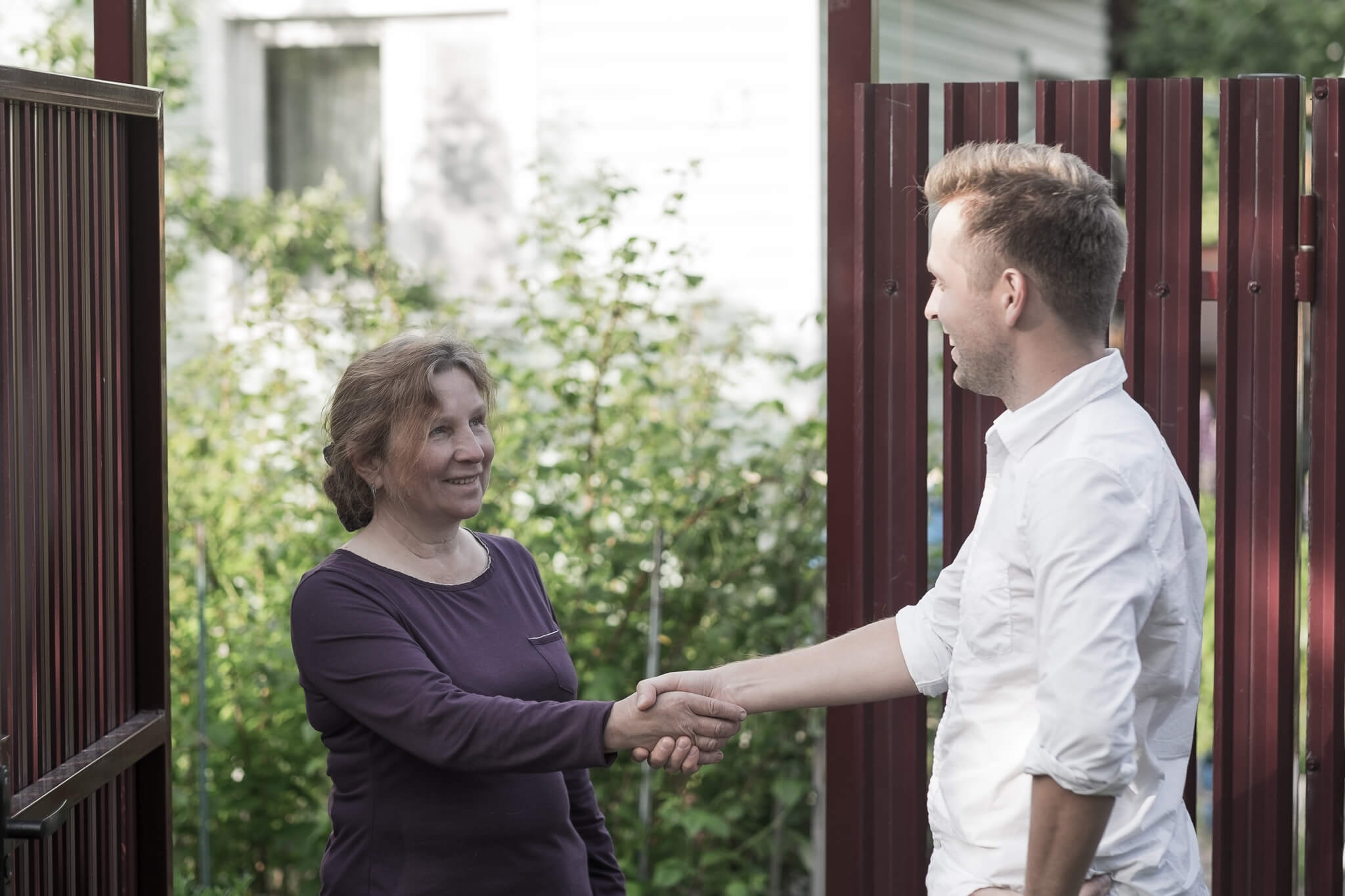 Two people greeting each other outside Derventio supported housing